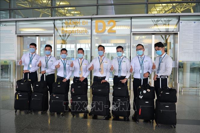 Photo: The flight attendants of national flag carrier Vietnam Airlines before departure. VNA Photo