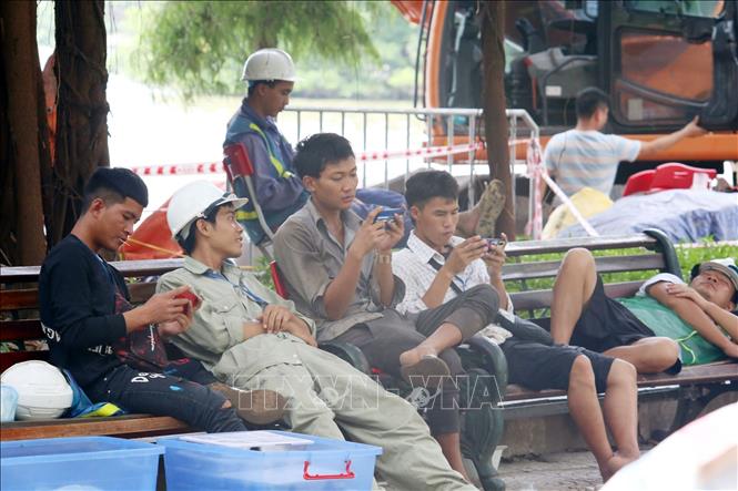 Trong ảnh: Lực lượng công nhân thi công kè hồ Hoàn Kiếm không đeo khẩu trang và không thực hiện đúng giãn cách (ảnh chụp trưa 1/8). Ảnh: Anh Tuấn - TTXVN