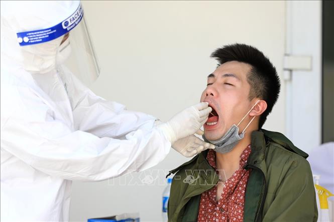 Trong ảnh: Lấy mẫu dịch hầu họng để xét nghiệm RT-PCR tại Trung tâm Văn hóa Thông tin và Thể Thao quận Đống Đa (237 Đặng Tiến Đông) - nơi xét nghiệm cho người dân quận Đống Đa trở về từ Đà Nẵng. Ảnh: Thành Đạt - TTXVN