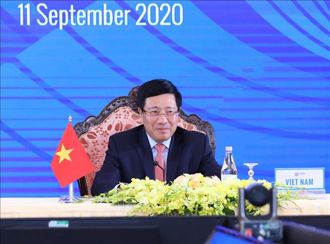 Photo: Vietnamese Deputy Prime Minister, Foreign Minister Pham Binh Minh chairs the meeting from Hanoii. VNA Photo: Lâm Khánh