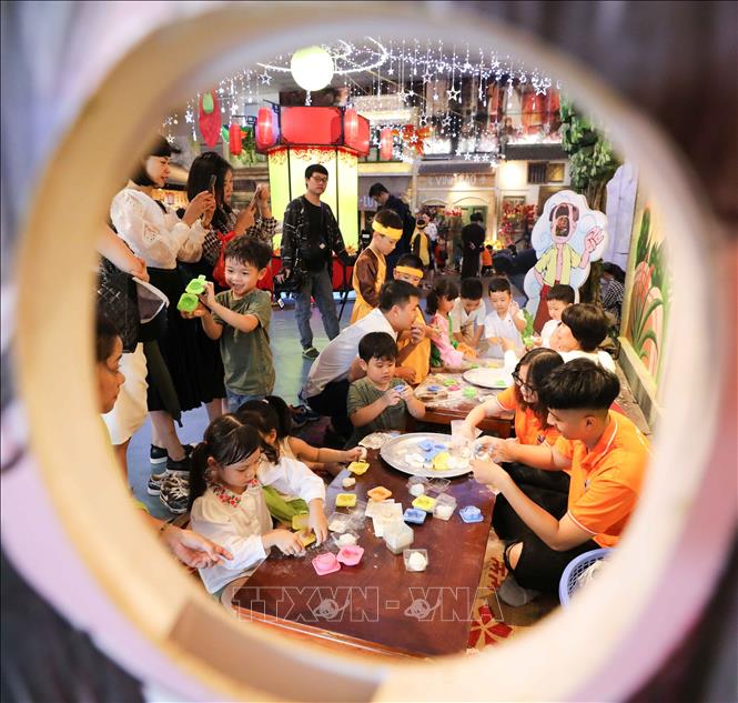 Trong ảnh: Các em nhỏ cùng làm bánh trung thu. Ảnh: Thanh Tùng - TTXVN 