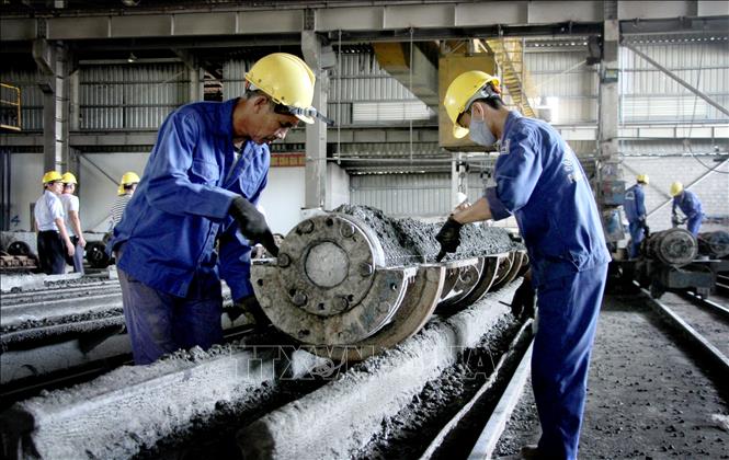 Công nhân Công ty TNHH Bê tông Phan Vũ Quảng Bình (Khu công nghiệp cảng biển Hòn La, Quảng Trạch, Quảng Bình) hoàn thiện các sản phẩm. Ảnh: Văn Tý-TTXVN