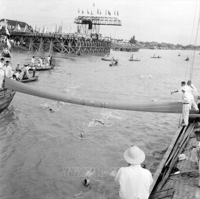 Trong ảnh: Cuộc thi bơi vượt sông Hồng toàn miền Bắc 1961, sáng 16/7/1961, tại Hà Nội. Ảnh: TTXVN