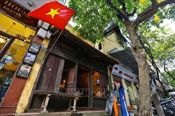 Photo: The house features traditional Vietnamese architecture to serve both as a residence and shop with a big window on the ground floor.  VNA Photo

 