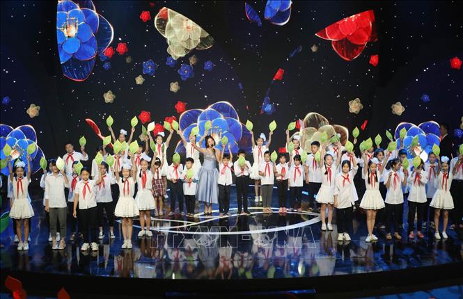 Trong ảnh: Tiết mục Mashup Điều em muốn + Hãy mỉm cười do ca sỹ Văn Mai Hương và 12 em nhỏ biểu diễn tại Chương trình. Ảnh: Anh Tuấn – TTXVN