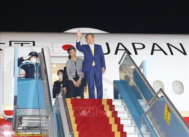 Photo: Japanese Prime Minister Suga Yoshihide and his wife arrive at Noi Bai International Airport. VNA Photo: Doãn Tấn