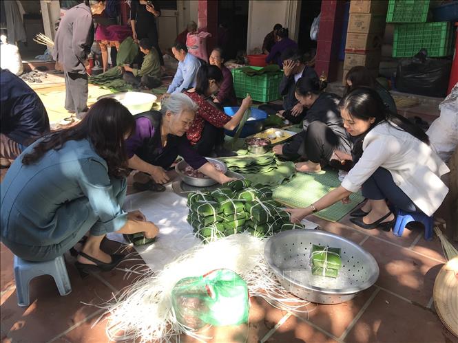 Trong ảnh: Người dân La Phù cùng nhau gói bánh chưng. Ảnh: Nguyễn Cúc - TTXVN
