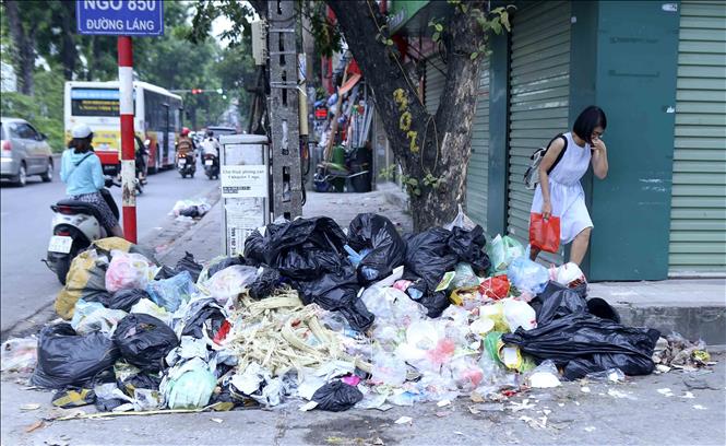 Trong ảnh: Tại khu vực đường Láng, những bãi rác tại đây khiến người đi đường khó chịu vì bốc mùi (ảnh chụp ngày 25/10). Ảnh: Tuấn Đức - TTXVN