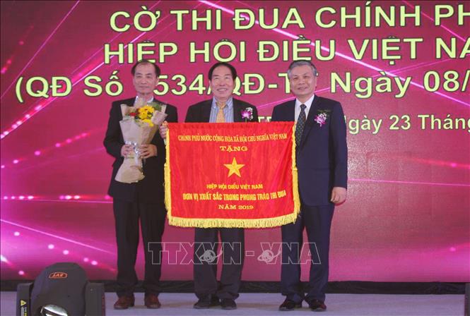Trong ảnh: Hiệp hội Điều Việt Nam nhận cờ thi đua của Chính phủ nhân kỷ niệm 30 năm thành lập. Ảnh: Xuân Anh –TTXVN 