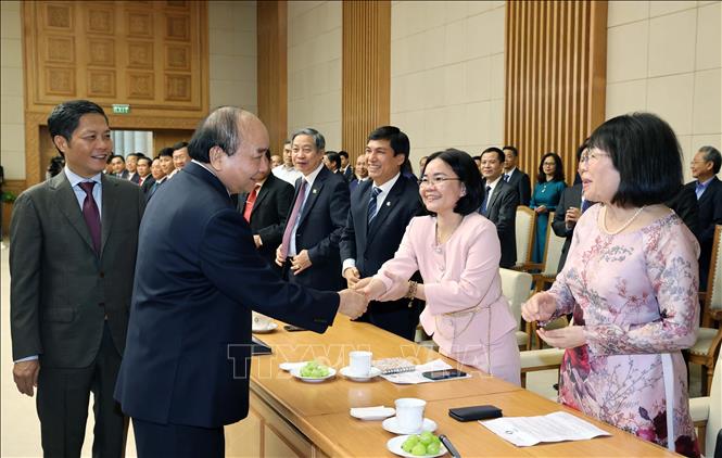 Photo: Prime Minister Nguyen Xuan Phuc meets representatives from Vietnam National Brand enterprises. VNA Photo: Thống Nhất
