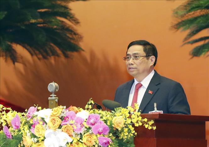 Photo: Secretary of the Party Central Committee, Head of the Party Central Committee's Organisation Commission Pham Minh Chinh delivers the delegate eligibility verification report. VNA Photo