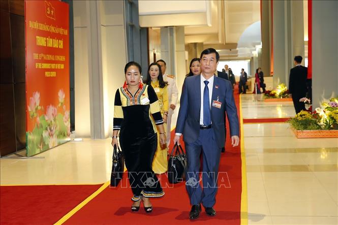 Photo: Delegates arrive to attend the 13th National Party Congress's opening session. VNA Photo