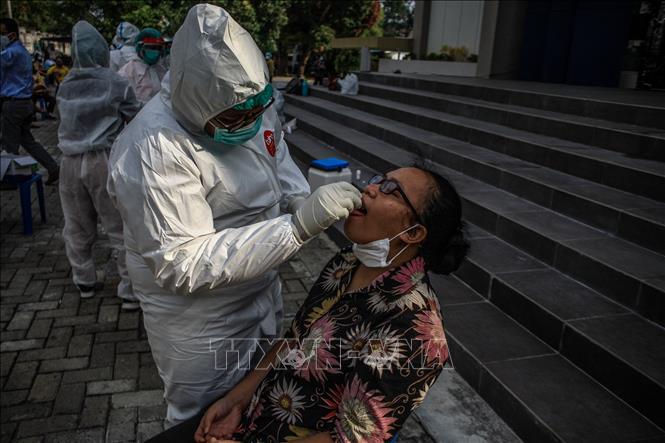 Trong ảnh: Nhân viên y tế lấy mẫu xét nghiệm COVID-19 cho người dân tại Medan, Bắc Sumatra, Indonesia, ngày 19/2/2021. Ảnh: THX/ TTXVN