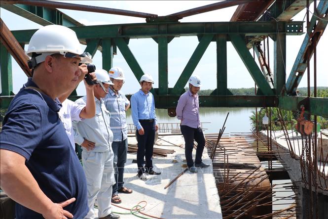 Photo: A bridge on the Tan Tap-Long Hau road is under construction. VNA Photo: Bùi Giang