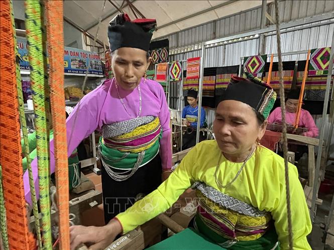 Trong ảnh: Bà Phạm Thị Bảo luôn tìm cách để bảo tồn và phát triển nghề dệt thổ cẩm trên đất Mường bằng cách tận tình chỉ dạy cho các chị em và thế hệ sau. Ảnh: Khiếu Tư -TTXVN
