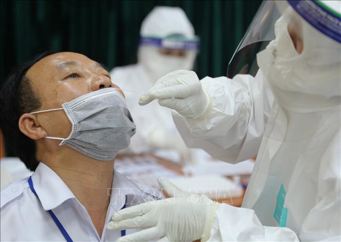 Trong ảnh: Lấy mẫu xét nghiệm COVID-19 cho công nhân viên Bến xe Giáp Bát. Ảnh: Hoàng Hiếu - TTXVN