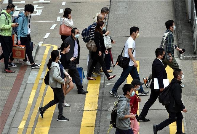 Trong ảnh: Người dân di chuyển trên đường phố tại Hong Kong, Trung Quốc, ngày 1/3/2021. Ảnh: THX/TTXVN