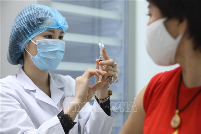 Photo: A volunteer receives the second shot of the Nano Covax COVID-19 vaccine in the second trial phase. VNA Photo: Minh Quyết