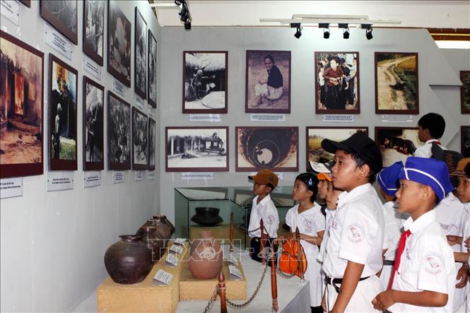 Học sinh trường Tiểu học Mỹ Khê xem các hình ảnh, hiện vật về sự kiện 504 thường dân vô tội bị thảm sát, được trưng bày tại Khu tưởng niệm Sơn Mỹ. Ảnh: Thanh Long - TTXVN