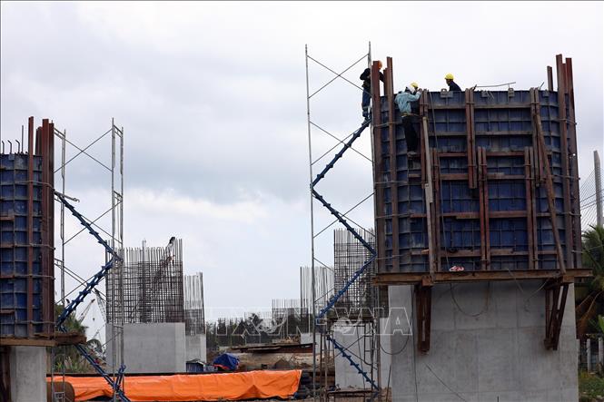 Trong ảnh: Thi công hạng mục cầu và đường dẫn bên phía tỉnh Vĩnh Long. Ảnh: Huy Hùng - TTXVN