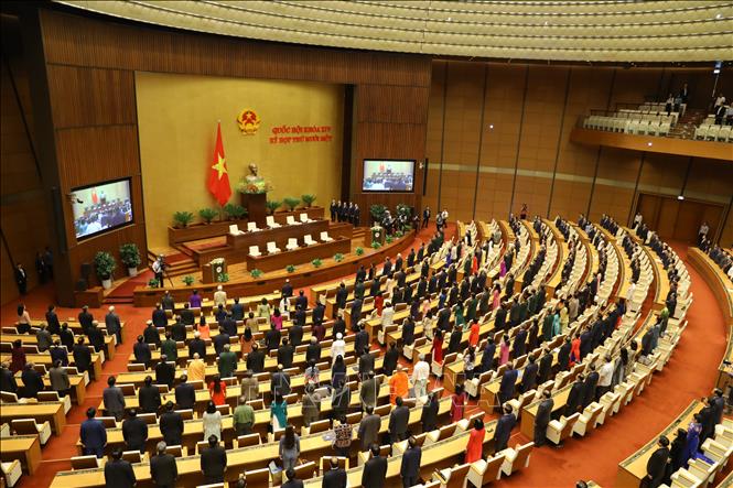 Photo: NA deputies salute the national flags at the closing session. VNA Photo