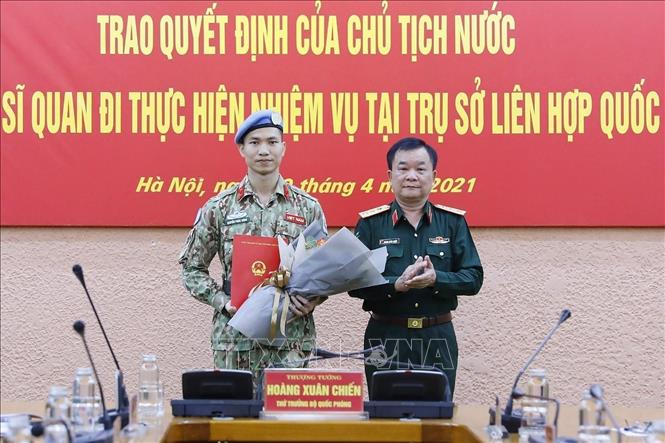 Photo: Deputy Defence Minister Sen. Lieut. Gen Hoang Xuan Chien hands over the President’s decision to Major Nguyen Phuc Dong. VNA Photo: Dương Giang