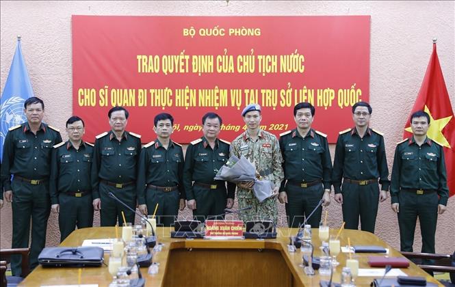 Photo: Deputy Defence Minister Sen. Lieut. Gen Hoang Xuan Chien hands over the President’s decision to Major Nguyen Phuc Dong. VNA Photo: Dương Giang