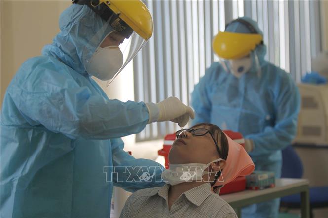 Trong ảnh: Các y bác sỹ Trung tâm y tế Quận 7 thực hiện xét nghiệm sàng lọc COVID-19 ngẫu nhiên cho công nhân tại Công ty TNHH Kim may Organ Việt Nam. Ảnh: Thanh Vũ - TTXVN
