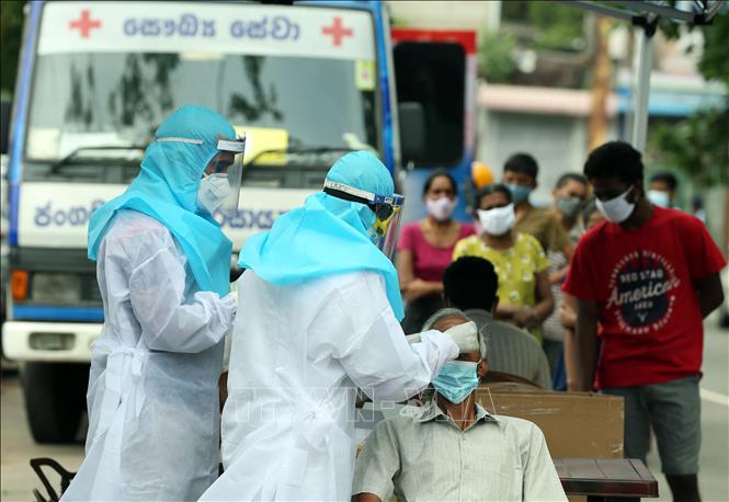 Trong ảnh: Nhân viên y tế lấy mẫu xét nghiệm COVID-19 cho người dân ở Colombo, Sri Lanka, ngày 24/5/2021. Ảnh: THX/TTXVN