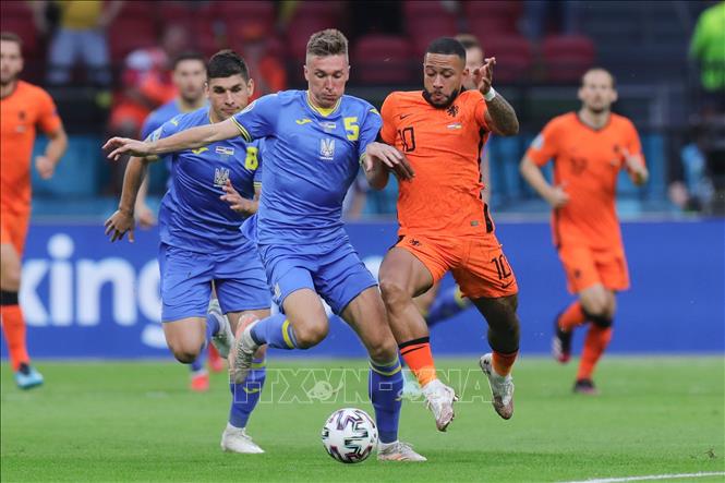 Trong ảnh: Tiền đạo Hà Lan Denzel Dumfries (phải, phía trước) tranh bóng với cầu thủ Ukraine Serhiy Sydorchuk trong trận đấu tại vòng chung kết EURO 2020 ở Amsterdam, ngày 13/6/2021. Ảnh: THX/TTXVN