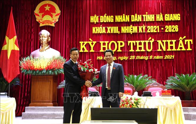 Trong ảnh: Bí thư Tỉnh ủy Hà Giang Đặng Quốc Khánh (phải) tặng hoa chúc mừng đồng chí Nguyễn Văn Sơn tái đắc cử Chủ tịch UBND tỉnh Hà Giang khóa XVIII, nhiệm kỳ 2021-2026. Ảnh: Minh Tâm-TTXVN
