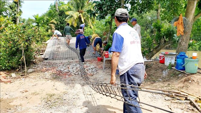 Tổ vận động xây cầu, đường Thới Hòa đang hoàn thành cầu ông Nhiệm, ấp Thới Hòa, phường Thới An. Ảnh: Thu Hiền - TTXVN