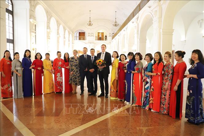 Trong ảnh: Thị trưởng Leipzig, ông Burkhard Jung (người cầm hoa), chụp ảnh lưu niệm với Đại sứ Nguyễn Minh Vũ (người đứng cạnh) và đại diện cộng đồng người Việt ở Leipzig. Ảnh: Mạnh Hùng - P/v TTXVN tại Đức