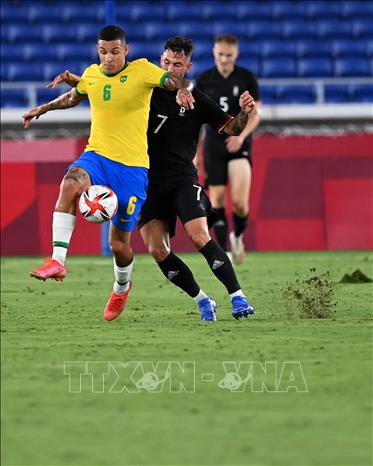 Trong ảnh: Hậu vệ tuyển Olympic Brazil Guilherme Arana (phía trước) nỗ lực đi bóng trong trận đấu mở màn bảng D gặp tuyển Đức ở Olympic Tokyo 2020 trên sân Yokohama, Nhật Bản ngày 22/7/2021. Ảnh: THX/TTXVN