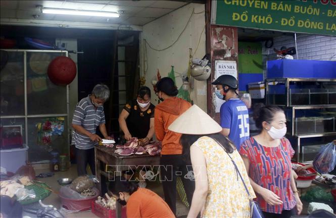 Trong ảnh: Nhiều người dân vẫn không tuân thủ việc giãn cách khi đi chợ. Ảnh: Tuấn Đức - TTXVN