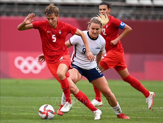 Trong ảnh: Trung vệ Quinn (trái) đội Canada tranh bóng với Lindsey Horan (phải), đội tuyển Mỹ trong trận đấu vòng bán kết môn bóng đá nữ Olympic 2020 diễn ra trên sân vận động Ibaraki Kashima ở Kashima, Nhật Bản, ngày 2/8/2021. Ảnh: AFP/TTXVN