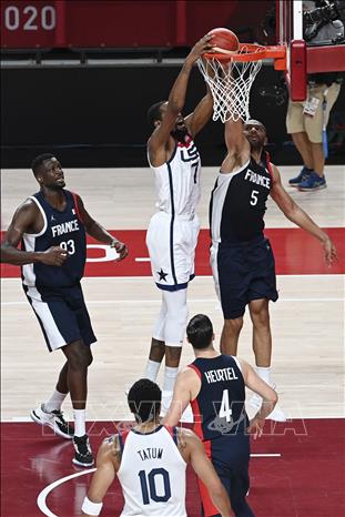 Trong ảnh: Tuyển thủ Mỹ Kevin Durant (giữa) lên rổ trước sự cản phá của tuyển thủ Pháp Nicolas Batum (phải) trong trận chung kết bóng rổ nam Olympic Tokyo 2020, diễn ra tại Saitama, Nhật Bản ngày 7/8/2021. Ảnh: AFP/TTXVN