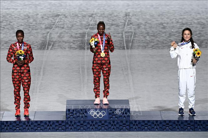 Trong ảnh: Ban tổ chức trao HCV cho VĐV marathon Peres Jepchirchir (giữa), HCB cho VĐV marathon Brigid Kosgei (trái) của Kenya và HCĐ cho VĐV marathon Molly Seidel (phải) của Mỹ tại lễ bế mạc Olympic Tokyo 2020 trên sân vận động Olympic ở Tokyo, Nhật Bản ngày 8/8/2021. Ảnh: AFP/TTXVN