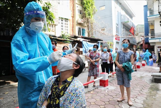 Trong ảnh: Sau 3 ngày, lực lượng y tế đã lấy mẫu xét nghiệm các điểm nóng trên địa bàn phường và hôm nay tiếp tục xét nghiệm toàn bộ nên một số người dân nằm trong diện được lấy mẫu 2 lần. Tính đến ngày 12/8, trên địa bàn phường Văn Chương đã có 30 ca F0, trong đó có 28 ca nằm trong khu phong tỏa trước đó. Ảnh: Thành Đạt - TTXVN