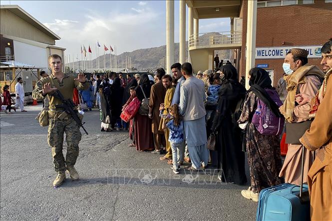 Trong ảnh: Dòng người xếp hàng lên máy bay sơ tán tại sân bay Hamid Karzai ở Kabul, Afghanistan ngày 18/8/2021. Ảnh: AFP/TTXVN
