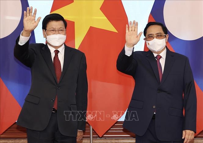 Thủ tướng Chính phủ Phạm Minh Chính hội kiến Tổng Bí thư Ban Chấp hành Trung ương Đảng Nhân dân Cách mạng Lào, Chủ tịch nước Cộng hòa Dân chủ Nhân dân Lào Thongloun Sisoulith thăm chính thức Việt Nam (28/6/2021). Ảnh: Dương Giang-TTXVN