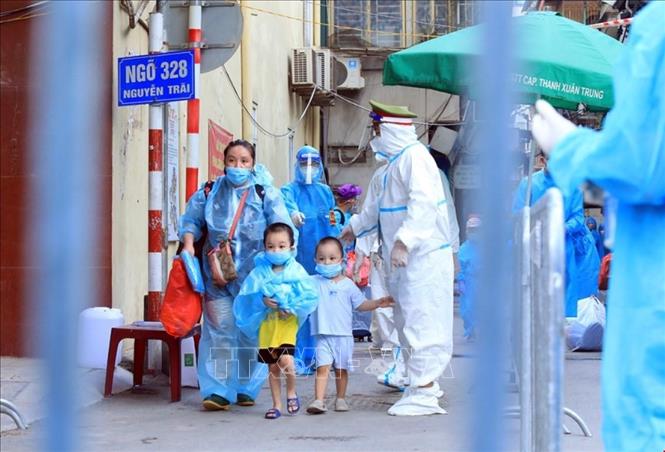 Trong ảnh: Trẻ em theo gia đình di chuyển đến khu cách ly. Ảnh: Tuấn Anh - TTXVN