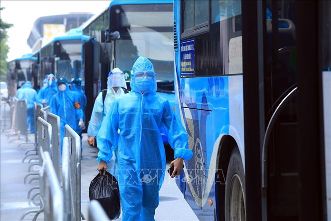 Trong ảnh: Người dân lên xe để di chuyển đến khu cách ly. Ảnh: Tuấn Anh - TTXVN
