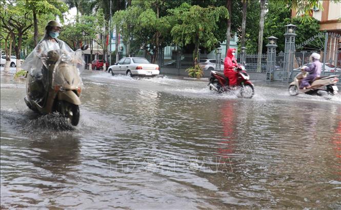 Trong ảnh: Mưa to gây ngập tại nhiều đoạn đường trong thành phố, khiến người và phương tiện gặp nhiều khó khăn khi tham gia giao thông. Ảnh: Nguyễn Công Hải-TTXVN