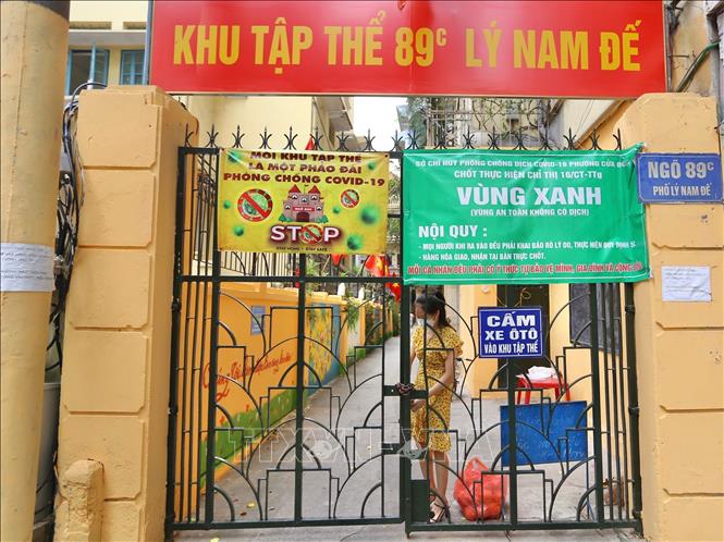 Trong ảnh: Tại “vùng xanh” trên đường Lý Nam Đế (phường Cửa Đông, Hoàn Kiếm), người dân vẫn giữ thói quen ra khóa cổng khi ra vào để phòng, chống COVID-19. Ảnh: Hoàng Hiếu - TTXVN