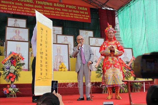 Giáo sư Vũ Khiêu tặng câu đối cho dòng họ Trần Việt Nam tại lễ đón nhận Bằng của Liên hiệp các hội UNESCO Thế giới tôn vinh các giá trị di sản lịch sử và văn hóa thời Trần thế kỷ XIII, ngày 14/9/2016, tại Đền thờ Tổ họ Trần Việt Nam (xã Thái Phương, huyện Hưng Hà, tỉnh Thái Bình). Ảnh: An An - TTXVN