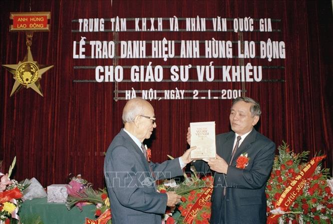 Ngày 2/1/2001, tại Hà Nội, Trung tâm Khoa học xã hội và Nhân văn quốc gia tổ chức lễ trao tặng danh hiệu Anh hùng Lao động thời kỳ đổi mới cho Giáo sư Vũ Khiêu. Trong ảnh: GS, Viện sĩ  Nguyễn Duy Quý thay mặt Trung tâm Khoa học xã hội và Nhân văn quốc gia tặng Giáo sư Vũ Khiêu 10 tập Tuyển tập văn học Việt Nam. Ảnh: Nhan Sáng - TTXVN