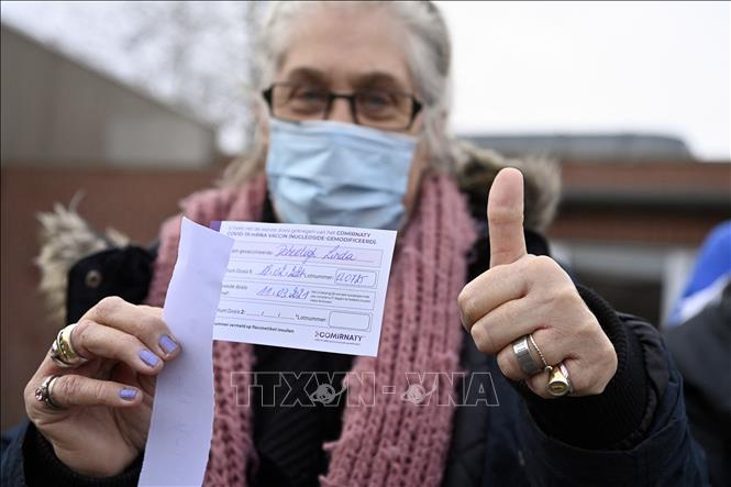 Trong ảnh: Một người dân nhận giấy Chứng nhận tiêm vaccine ngừa COVID-19 tại Overijse, Bỉ ngày 18/2/2021. Ảnh: AFP/TTXVN  