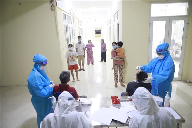 Trong ảnh: Lực lượng y tế tổ chức tổ chức xét nghiệm sàng lọc SARS-CoV-2 cho tất cả các trường hợp công dân cách ly tại Trung tâm đào tạo vận động viên Vĩnh Phúc. Ảnh: Hoàng Hùng - TTXVN