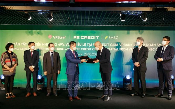 Trong ảnh: Đại diện VPBank và đại diện tập đoàn SMBC trao nhau chứng nhận hoàn tất giao dịch chuyển nhượng 49% vốn  góp tại FE Credit. Ảnh: Trần Việt - TTXVN